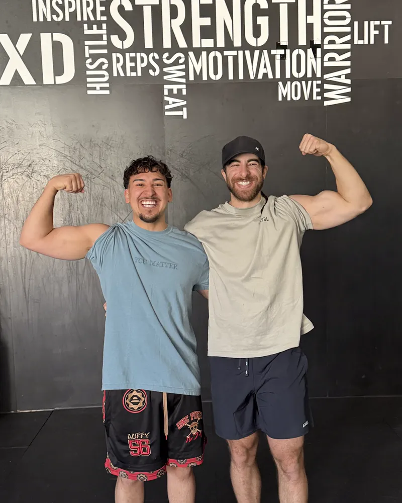 Isaiah Altamirano, Forge’s founder, flexing with a friend at the gym
